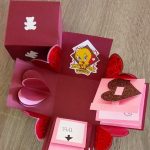 A homemade explosion box, tweety themed in the colors red and pink with hearts.